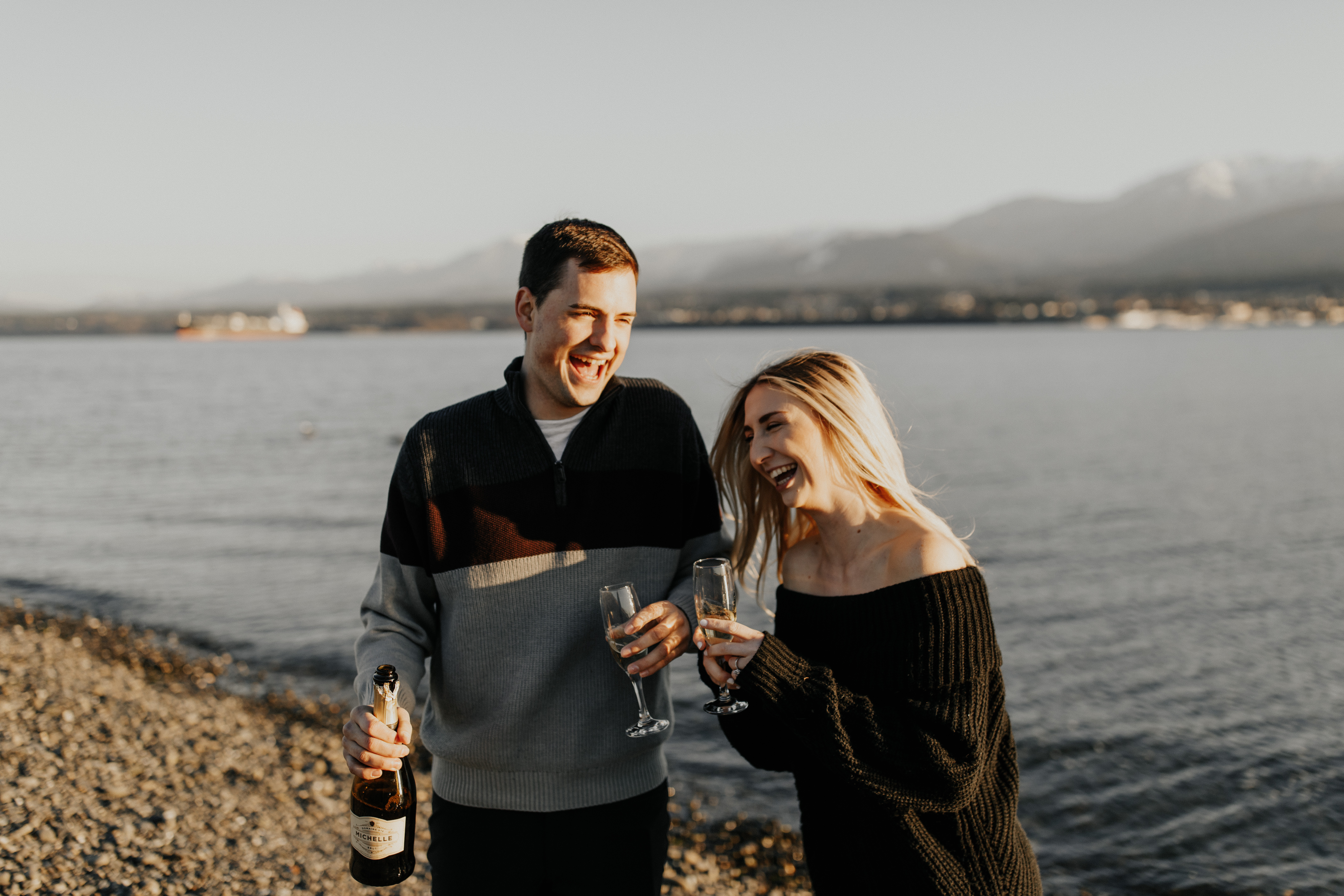 couple-popping-champagne-on-the-beach