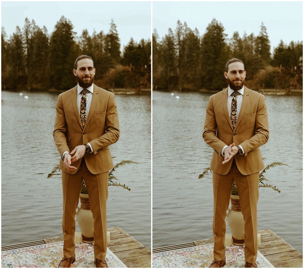groom standing in front of lake
