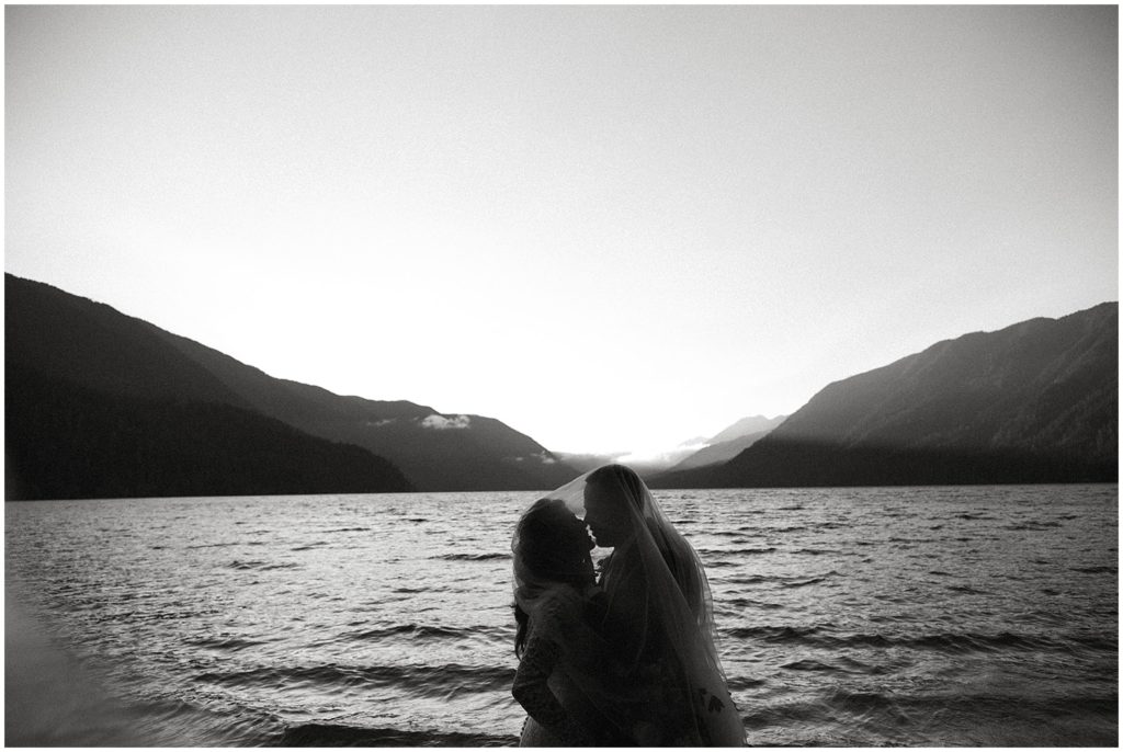Couple embracing each other in front of lake