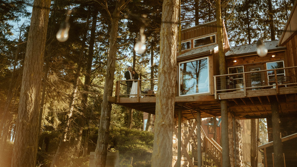 couple laughing inside of a treehouse