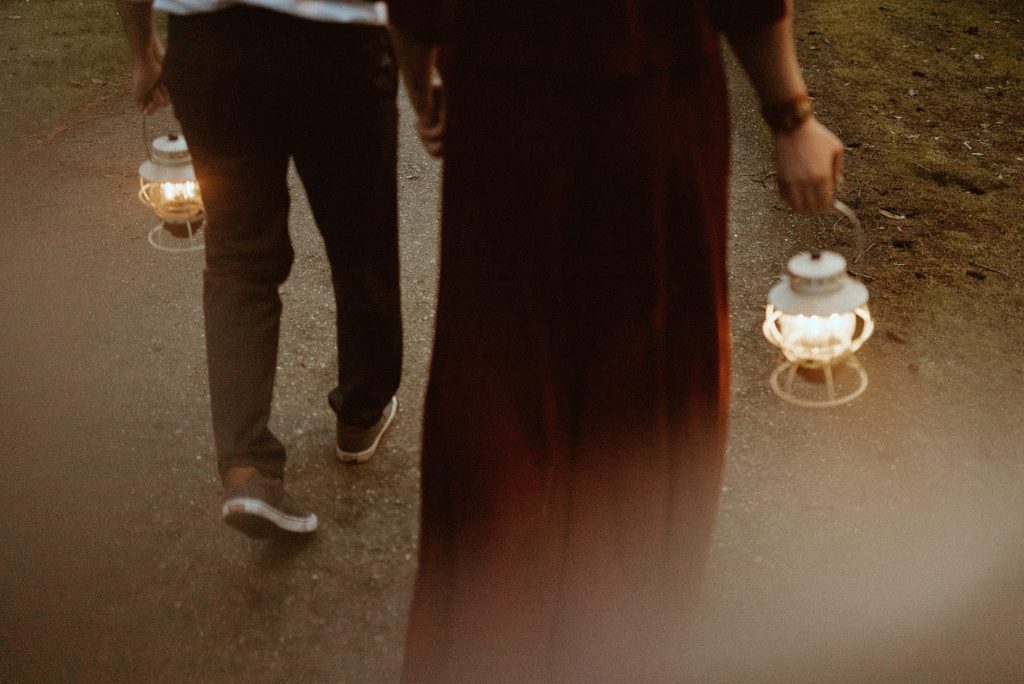 couple walking holding lamps