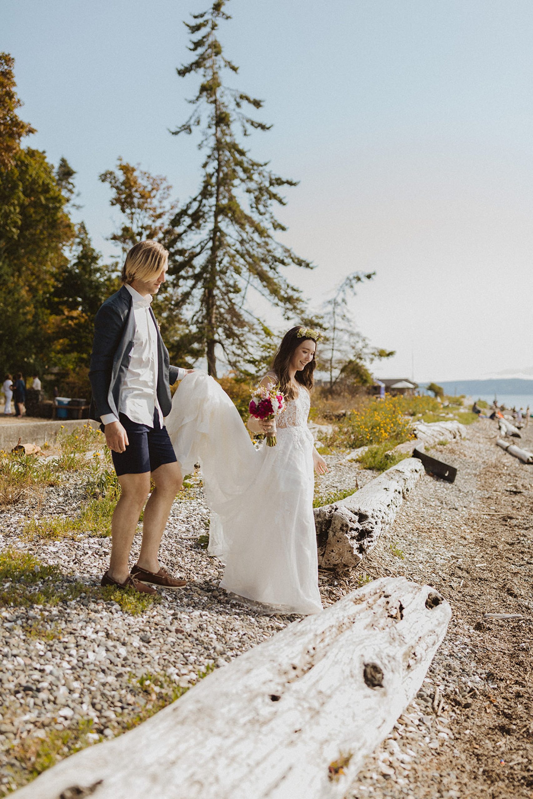groom holding wedding dress at camano island