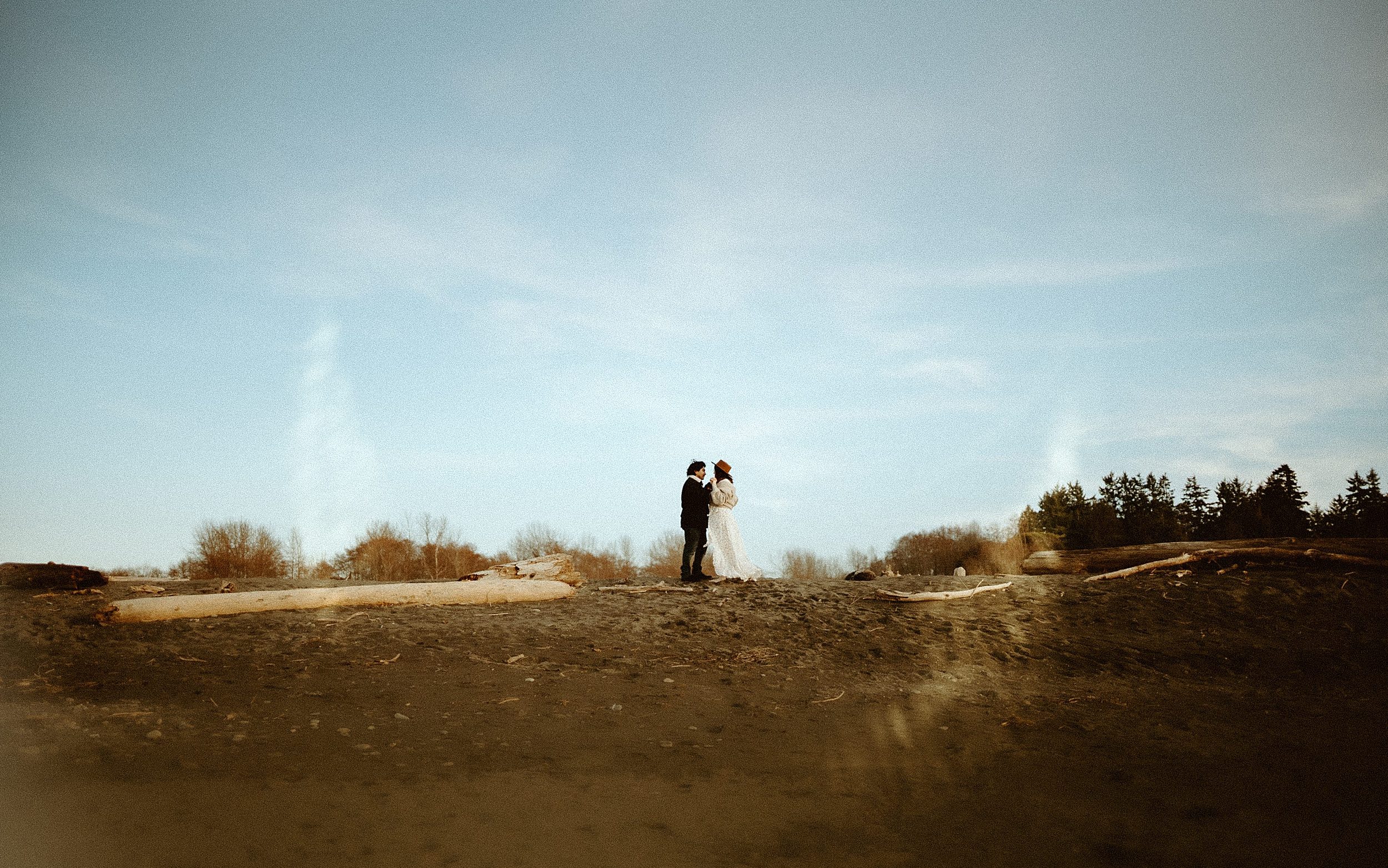 couple standing on beach landscape 