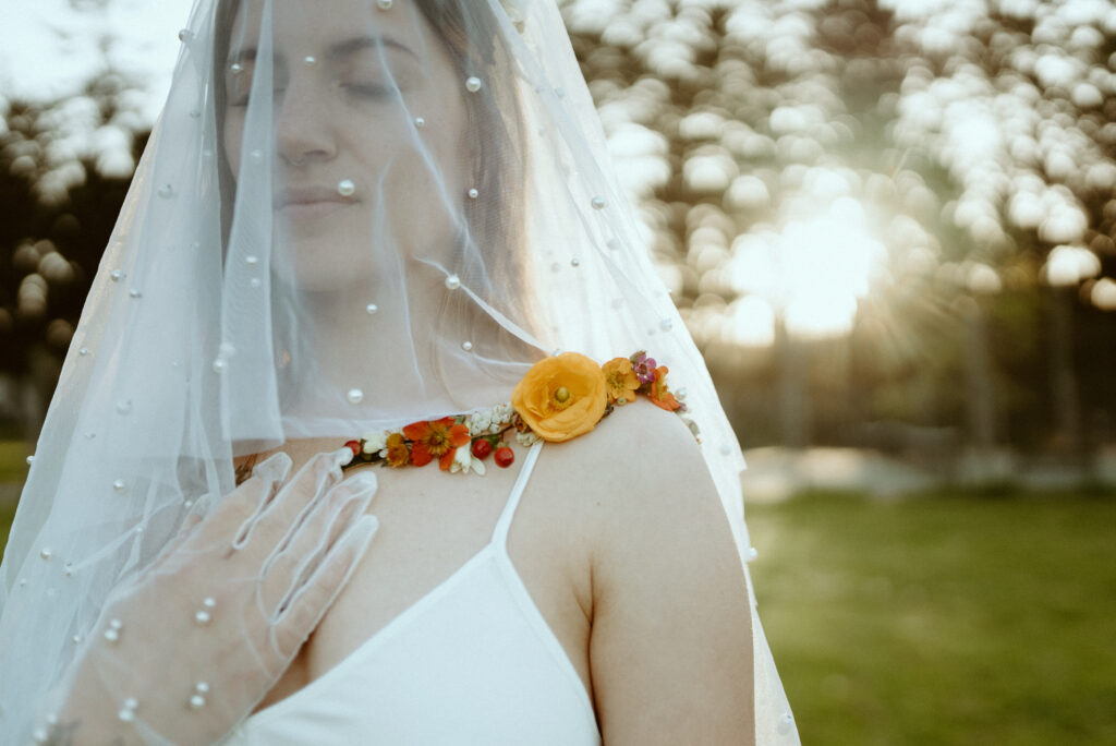 Wearable florals on bride collarbone 2023 Wedding Trend: Wearable Florals