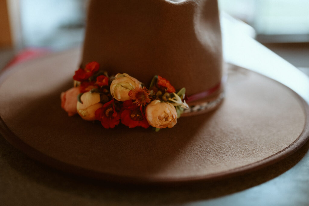 floral band on hat 2023 Wedding Trend: Wearable Florals