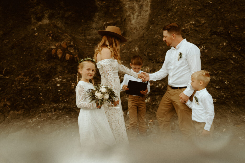 Couple exchanging vows with their children during their Salt Creek elopement