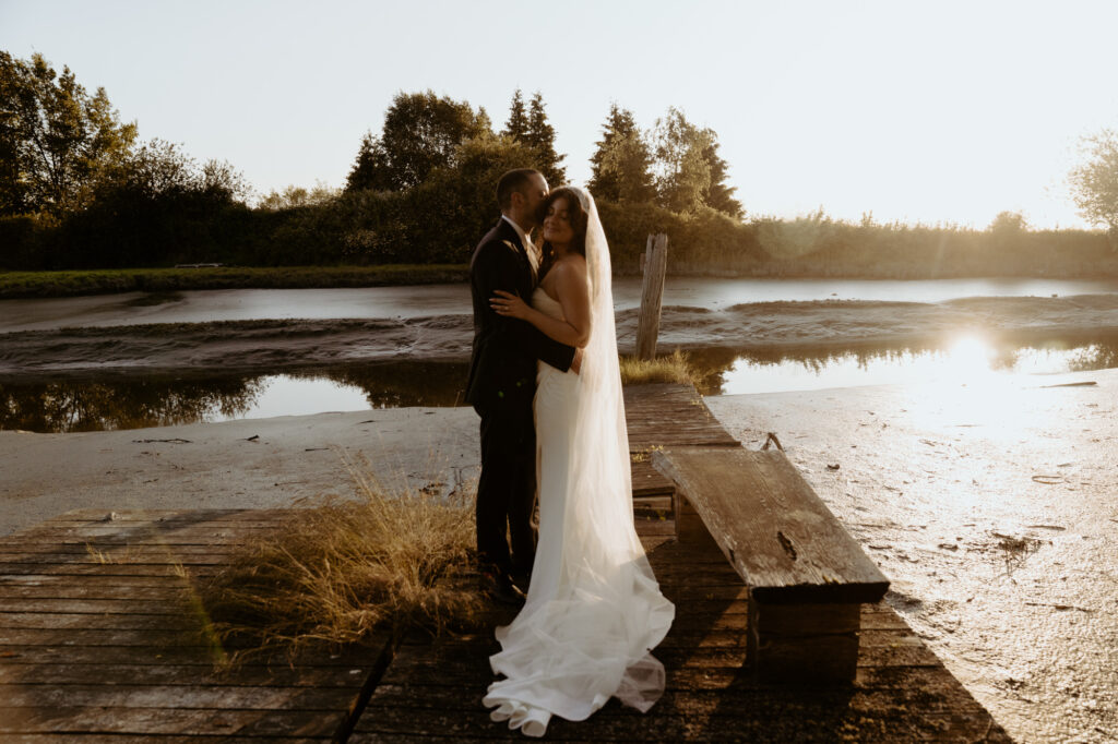 Bride and groom first look on deck overlooking Samish Bay