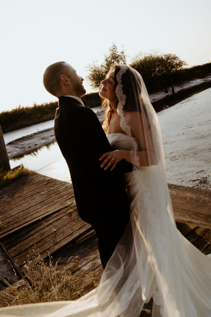 Couple walking down wooden steps toward water