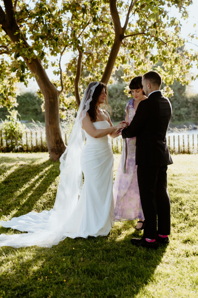 Couple exchanging vows by the water in Bow WA