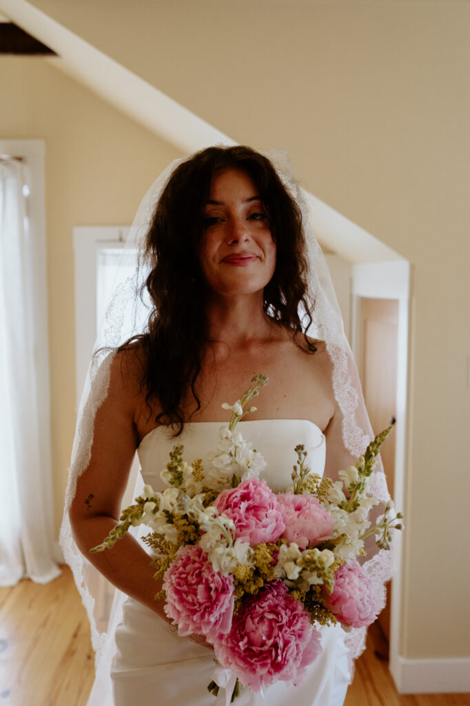Bride holding bouquet during intimate micro wedding