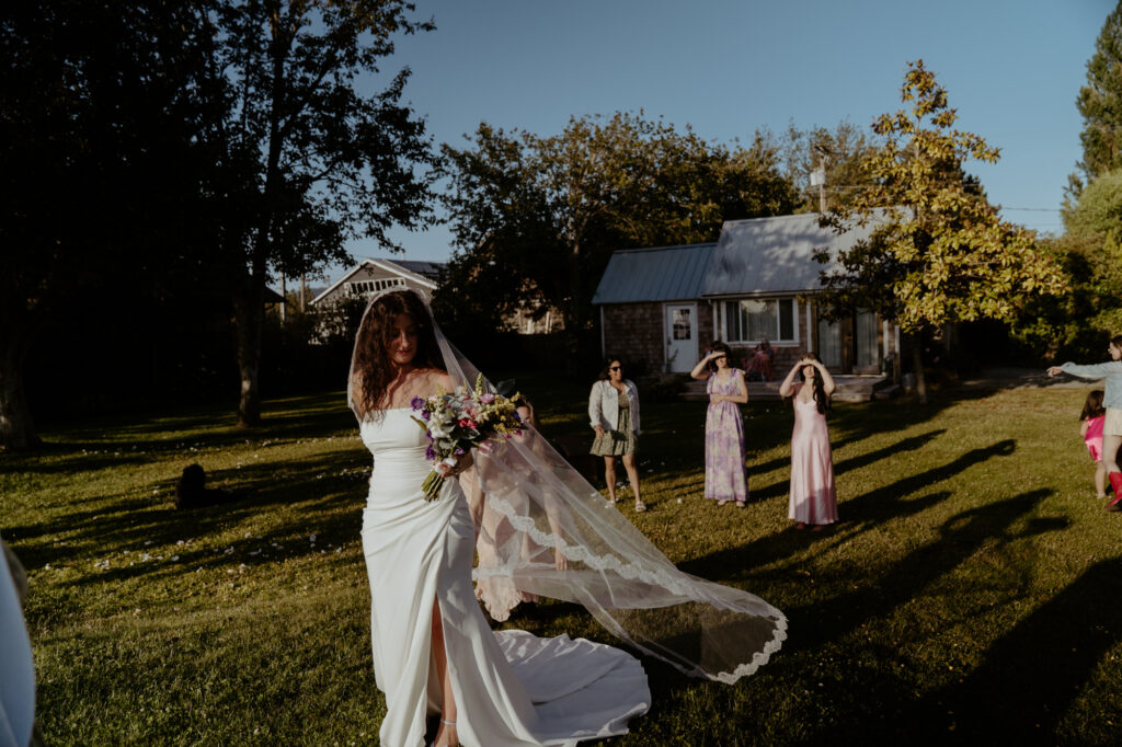 bride getting ready to throw her bouquet to bridesmaids