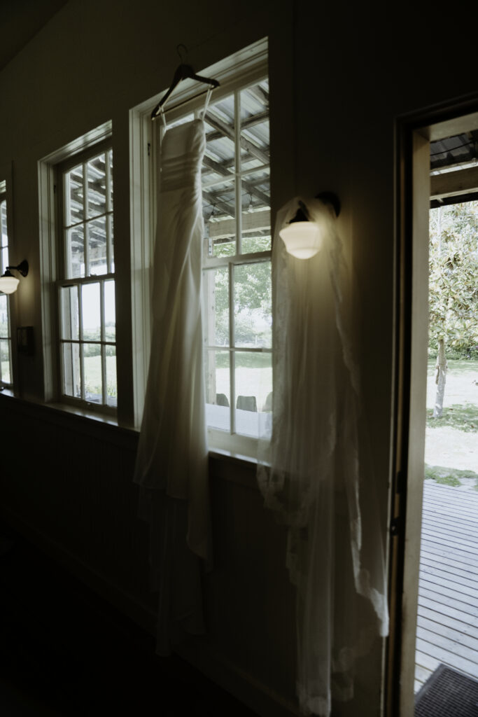 Bride’s dress hanging in window