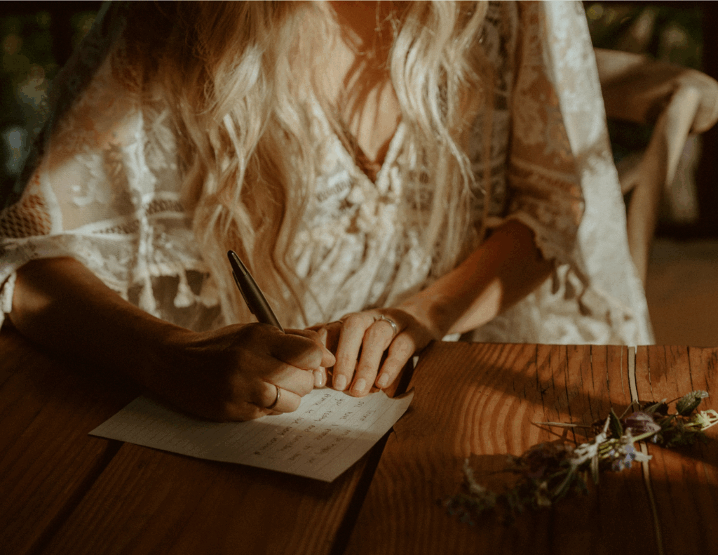 bride writing her vows in golden light